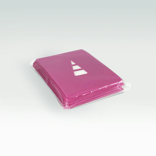 A stack of pink books wrapped in Unstable Games: Purple Card Sleeves, each featuring a white triangular logo on the cover, set against a light gray background.
