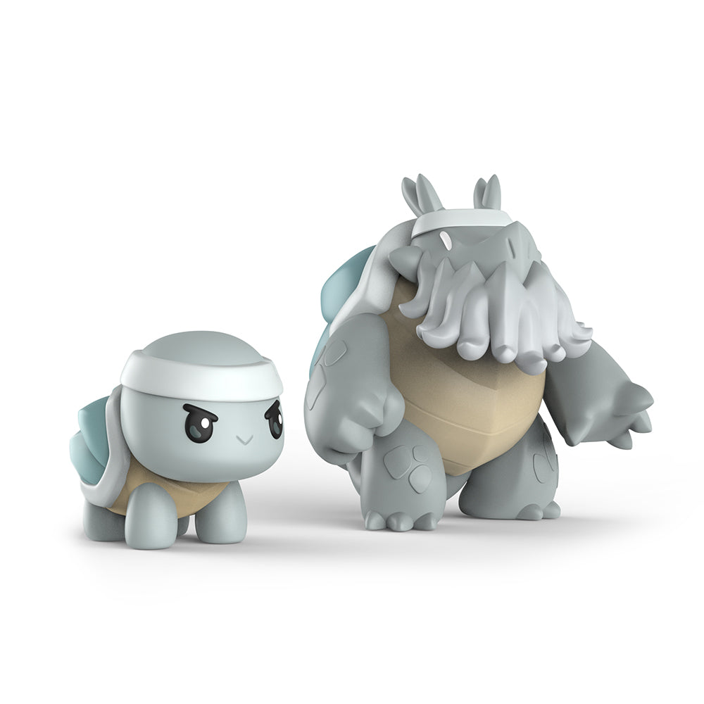 The Casting Shadows: Dread Terrashell & Dread the Ironclad Vinyl Figure Set by Unstable Games features two toy figures of fictional creatures. The smaller figure resembles a turtle with a headband, while the larger one, also turtle-like, sports a beard and headgear. Both figures showcase a gray and beige color scheme.