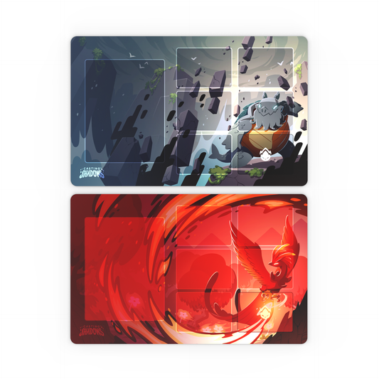 The Casting Shadows: Molten Rock Expansion Play Mat Set by Unstable Games includes two vibrant card game playmats; the top mat showcases a rocky creature amidst boulders on a blue background, while the bottom mat features a fiery bird in flight on a red background.