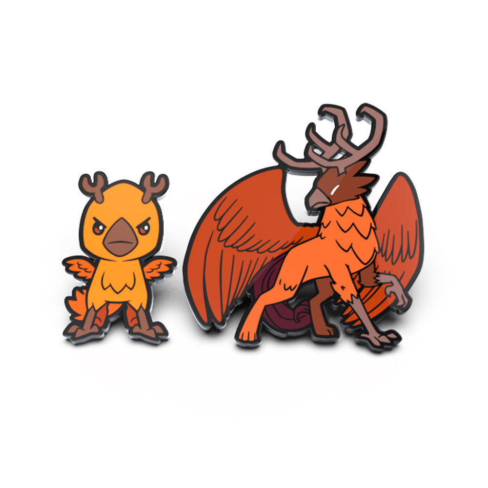 Two enamel pins: one depicting a small orange creature with horns and wings, and the other a larger beast named Talon Lightfeather with antlers and feathered wings from the Talon Lightfeather & Talon the Dark Storm Enamel Pin Set by Unstable Games.