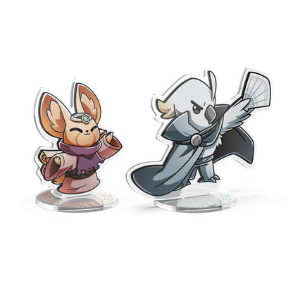 Introducing the Command of Nature: Sand & Wind Expansion Standee Set by Unstable Games. This set features two cartoon-style animal character standees that are perfect as desk toys. The left figure is a small, hooded creature holding a scroll, and the right figure is a bird-like creature in a cloak wielding a net. Their intricate details exude an almost magical Command of Nature vibe.