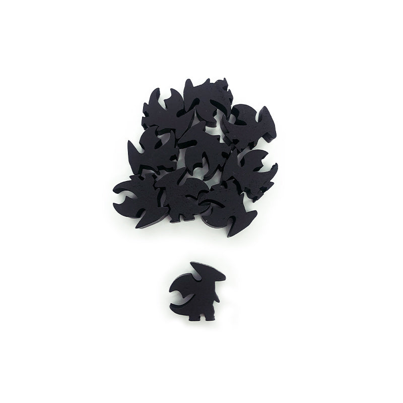 A group of small, black, dragon-shaped wooden meeples from the Here to Slay: Dragon Class Meeple Set by Unstable Games arranged in an irregular cluster, with one piece slightly separated from the group on a white background.
