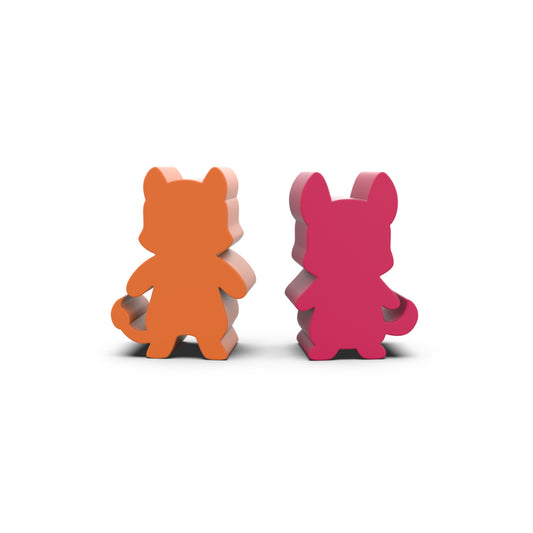 Two cat-shaped, standing figures with a simple design, one orange and the other pink, placed against a white background, reminiscent of the charming wooden meeples from 