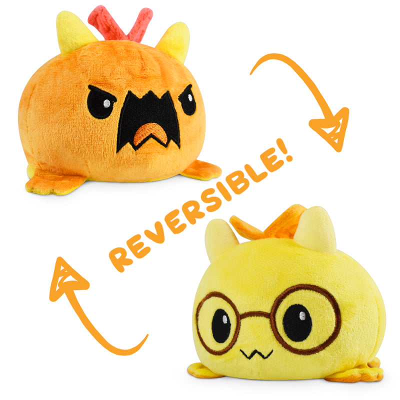 Tic Tac K.O. Dragons vs. Unicorns: Tantrum & Book Wyrm Reversible Plushie from Unstable Games showing an angry orange creature and its alternate happy yellow form with glasses.