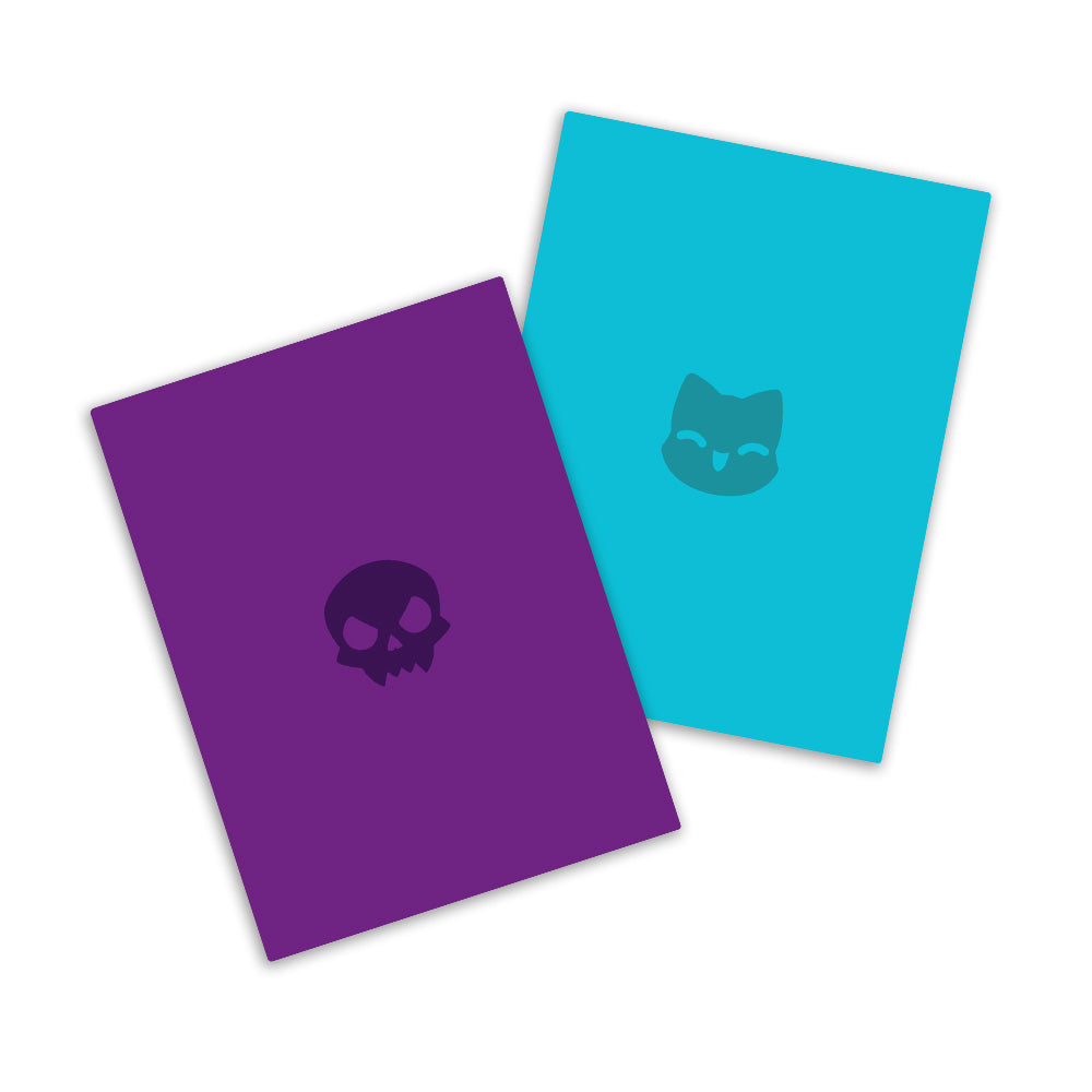 Two notebooks with distinct covers; one purple with a Tic Tac K.O. icon, the other turquoise with a cat face. They resemble the design of the Tic Tac K.O. Cute vs. Evil: Team Cute + Team Evil Card Sleeve Bundle from Unstable Games.