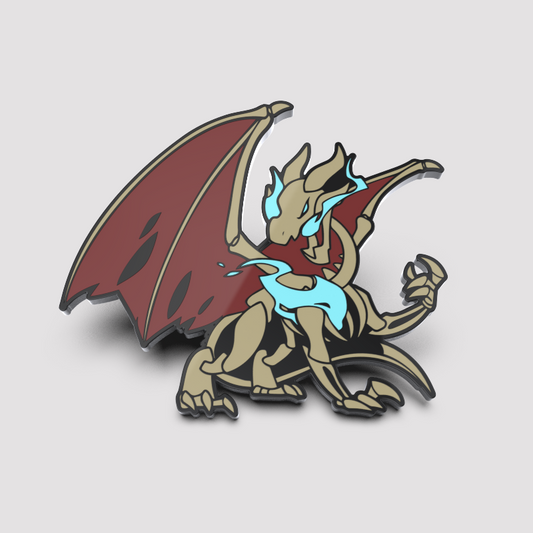 Enamel pin featuring a stylized Dracos Pin with expanded red wings, beige body, and a blue flame-like design on its chest by Unstable Games.