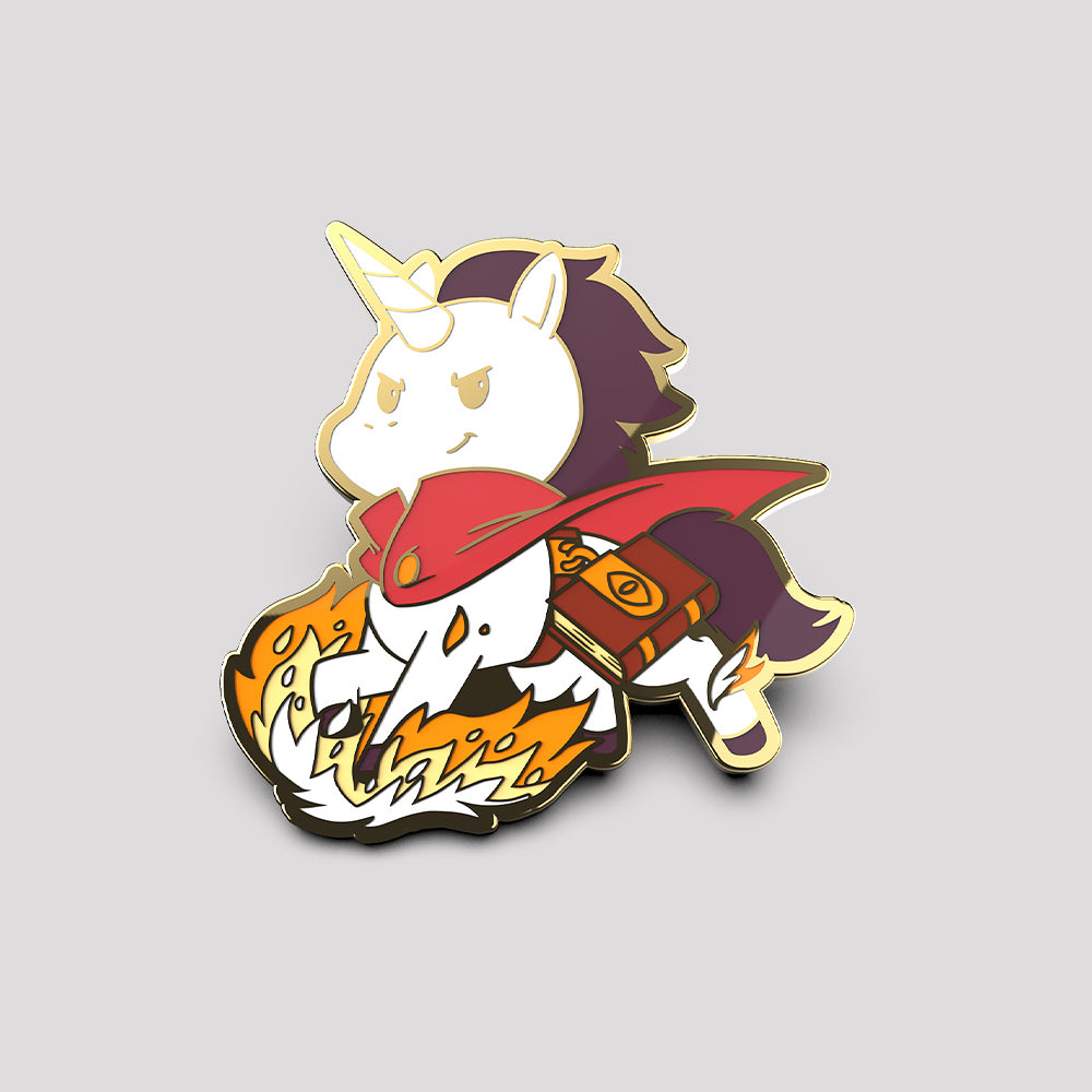 A Wizard Unicorn Pin shaped like a cartoon unicorn wearing a red cape and armor, crafted from metal and enamel, charging forward with flames at its hooves by Unstable Games.