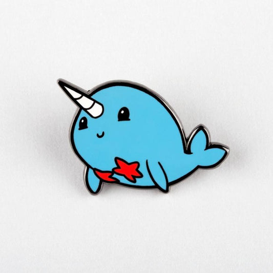 A Narwhal Pin badge featuring a cute blue narwhal with a unicorn horn and a red star on its side, perfect for sea-themed enamel pins collections by Unstable Games.