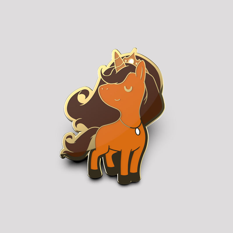 Queen Bee Unicorn Pin enamel pin featuring a cartoon-style brown horse with a flowing dark mane and tail, wearing a golden crown. Wipe clean only.
