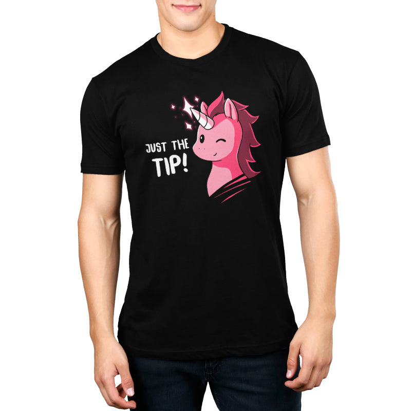 Man wearing a black Men's t-shirt featuring a graphic of a pink unicorn with the phrase "Just The Tip (UU)!" in white text by Unstable Games.